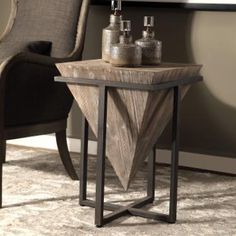 a wooden table sitting on top of a rug next to a chair