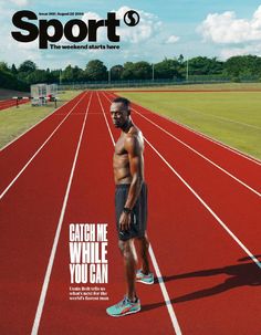 a man standing on top of a red running track