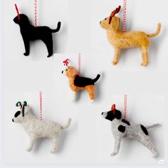 four different types of ornaments with dogs hanging from them's sides and one dog on the other side