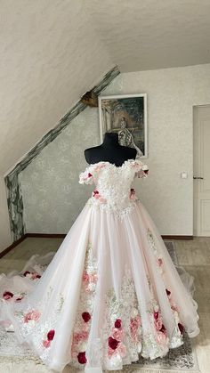 a dress is on display in a room with white walls and carpeted flooring