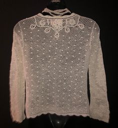 "A very lovely vintage imported sweater from China, I am told it's vintage 1950's. It appears in excellent condition, perhaps never worn. Tag reads that it's cotton and hand made, even the buttons are covered with the crocheted fabric. It's sized as a M, I would say more of a small by today's standards. The bust is 34\" when closed, sleeves are 20\" and the length from shoulder to hem is 22\", all unstretched measurements. Quite beautiful and very delicate looking!" Vintage Crochet Crew Neck Tops, Vintage Hand Knitted Crew Neck Sweater, Vintage Long Sleeve Tops With Crochet Lace, Vintage Long Sleeve Top With Crochet Lace, Fitted Vintage Hand Knitted Sweater, Vintage Fitted Hand Knitted Sweater, White Vintage Knitted Top, Vintage White Knitted Tops, Fitted Vintage Knitted Cardigan