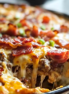 a close up of a pizza with cheese and meat