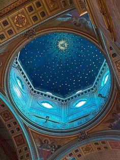 the inside of a building with a blue ceiling and stars on it's ceiling