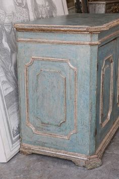 an old blue painted chest sitting on the floor