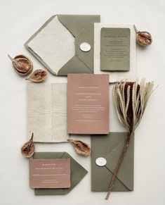 the wedding stationery is laid out on top of each other