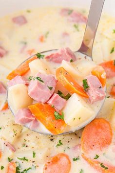 a spoon full of ham and potato soup