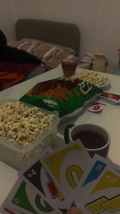 a table topped with lots of food and drinks on top of it next to a bag of popcorn