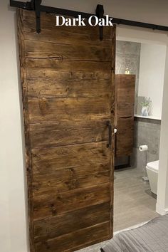 a bathroom with a wooden door in the middle and a bed on the other side