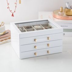 a white jewelry box sitting on top of a table