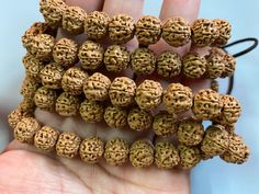 Material: Natural Rudraksha Bodhi Seed (Natural Wood, Fragrance Free ) Size: dia.10 mm QTY: full strand you will received Hand-strung Beaded Bracelets For Puja, Festival Mala With Large Round Beads, Hand-strung Beads For Puja, Brown Round Beads Mala For Puja, Spiritual Mala With Large Beads, Hand-strung Gold Beads For Beach, Rudraksha Beads Meaning, Traditional Large Brown Beads, Spiritual Brown Carved Beads