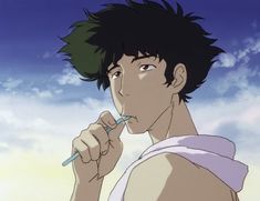 a young man brushing his teeth with an electric toothbrush in front of the sky