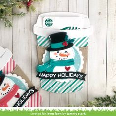 a holiday card with a snowman in a top hat, scarf and mittens