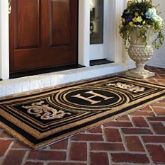 a door mat with the letters h and f on it in front of a house