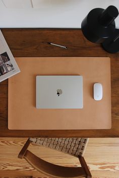 an apple computer sitting on top of a wooden desk