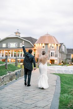 the bride and groom are walking down the path