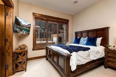 a bedroom with a large bed and wooden furniture