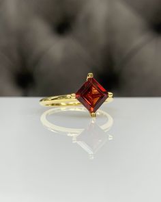 7 mm Princess / Square Red Garnet Dainty Ring, 14K Gold, Genuine Red Gemstone, 4 Prongs Modern Setting, Best Gift for Her, Handmade Ring ◎ Details ◎ ○ Gemstone Details .Natural RED GARNET Princess / Square Cut 7 mm x 7 mm approx. 1.85 ct ○ Gold Details 14K Solid Gold Weight of Ring : approx 3.00 gr Width of Band : 2.25 mm Made to Order HANDMADE ITEM ○ Upgrade to Solid 18K Gold, please click the link below: https://www.etsy.com/listing/962826004 ○ For more BIRTHSTONE Rings : https://etsy.me/2NNWR Classic Red Birthstone Ring With Ethical Gemstones, Timeless Ruby Ring Gift, Timeless Ruby Ring For Gift, Timeless Solitaire Ruby Ring Gift, Luxury Ruby Ring With Diamond Cut For Gift, Luxury Ruby Ring With Diamond Cut As Gift, 14k Gold Ruby Ring With Diamond Cut For Gift, Classic Diamond Cut Sapphire Ring As Gift, Timeless Red Ring As A Gift