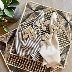 three napkins are sitting on a woven tray