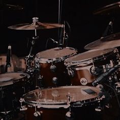 a drum set up in front of a black background with the drums on it's sides