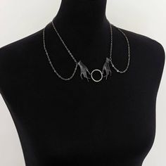 Gunmetal tone chains drape into a collar connected by two 2" oxidized black brass phantom hands clasping a 1" gunmetal circle. The chains close with a lobster clasp with a tiny triangle charm hanging down the back. The length of the necklace end to end is 18.25". All our materials are lead and nickel free. This necklace will come packaged in a matte black O.C.D. logo gift box with an O.C.D. logo button. *ALL PHOTOS, DESIGNS, TITLES, TEXT, AND DESCRIPTIONS ARE COPYRIGHTED PROPERTY OF OPEN THE CELLAR DOOR UNLESS NOTED OTHERWISE* *Please avoid direct contact with perfumes, hairspray, essential oils, etc.* SHIPS IN 3-5 BUSINESS DAYS Phantom Hands, Choker Necklace Black, D Logo, Black Choker Necklace, Cellar Door, Collar Choker, Black Goth, Logo Gifts, Choker Collar