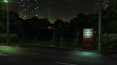 a vending machine sitting on the side of a road next to a street light