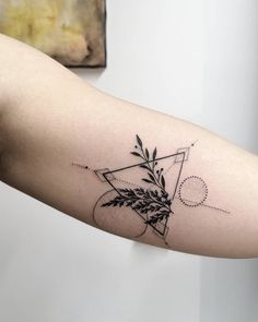 a black and white photo of a tattoo on the arm with an abstract design in it