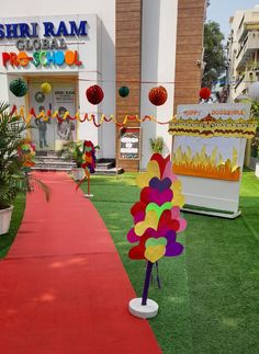 a red carpeted path leading to a building with decorations on the front and side