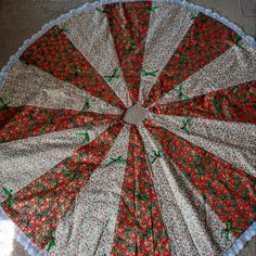 a red and white flowered umbrella laying on the floor