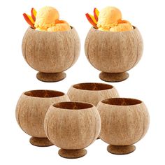 four wooden bowls filled with ice cream on top of each other in different shapes and sizes