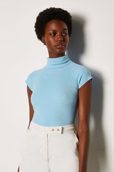 Softly does it. Take an understated approach to new-season styling with this sleeveless jumper. It features a roll neck, capped sleeves and pull-on fit. Turtleneck Sleeveless, Sleeveless Jumper, Capped Sleeves, Sleeveless Sweater, Roll Neck, Karen Millen, Fashion Face, Pale Blue, One Shoulder Blouse