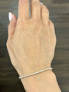 This beautiful delicate diamond tennis bracelet weights 2.50 ct and showcases 70 round diamonds. The diamonds boast a color of G/H and S12/I1 in color. A great bracelet if you are starting your jewelry collection. White Diamond Tennis Bracelet With Diamond Accents, White Diamond Bracelet With Accents, Diamond Tennis Bracelet With Jubilee Style, White Diamond Bracelet With Single Cut Diamonds, White Diamond Bracelet With Prong Setting, Fine Jewelry White Diamond Bracelet With Prong Setting, White Diamond Tennis Bracelet Bangle, White Tennis Bracelet With Single Cut Diamonds, White Round Cut Diamond Bracelet