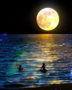 two people swimming in the ocean under a full moon