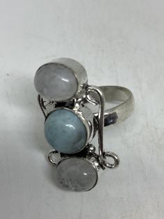 Huge blue Larimar white rainbow moonstone Lovely vintage silver setting is low content silver Size 8.5 Can be re sized for a $20 fee All rings are shipped in a nice gift box. Check out our over a THOUSAND great reviews Engraving is $4 per letter and is not always perfect depending on the piece. It can take a few days if the jeweler is busy. This is payable to Paypal Judithsltd@gmail.com Silver Larimar Jewelry For Healing, Handmade White Larimar Jewelry, White Larimar Round Jewelry, Unique Silver Larimar Rings, White Larimar Gemstone Jewelry, Silver Larimar Ring Stamped 925, Adjustable Blue Moonstone Ring, Blue Larimar Moonstone Ring, Blue Moonstone Ring With Natural Stones