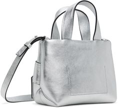 Crinkled leather shoulder bag in silver tone. · Fixed carry handles · Adjustable and detachable crossbody strap · Knotted accent at face · Zip closure · Card slot at interior · Fully lined · Silver-tone hardware · H5.75 x W8.5 x W3.75 Supplier color: Silver Silver Shoulder Bag With Top Carry Handle For Travel, Silver Shoulder Bag With Top Carry Handle For Everyday, Silver Top Handle Shoulder Bag For Shopping, Silver Satchel With Top Carry Handle For Formal Occasions, Formal Silver Satchel With Top Carry Handle, Silver Double Handle Satchel For Evening, Silver Double Handle Shoulder Bag, Silver Leather Top Handle Shoulder Bag, Modern Silver Shoulder Bag With Top Carry Handle