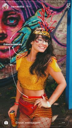 a woman in a yellow top and red skirt standing next to a wall with graffiti on it