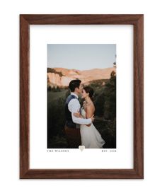 a couple kissing in front of mountains with a red heart on the bottom and a white background