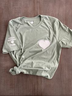 Unisex adult t-shirt in 100% soft cotton. Heart with I wear my heart on my sleeve around it on left side of chest. Names and heart on right sleeve. Don't see a color you want as an option? Reach out to us and we will be sure to try our best and fulfil your request. Live chat us directly on our site, dm us on Instagram, email us at cheeksandbubbles@gmail.com THIS ITEM GETS FREE ECONOMY SHIPPING! Care instructions - For best results wash inside out in cold water and tumble dry low. Cotton Graphic Tee With Heart Print, Casual Cotton T-shirt With Heart Patch, Cotton Graphic Tee With Heart Patch, Cotton T-shirt With Heart Graphic And Relaxed Fit, Cotton T-shirt With Heart Graphic In Relaxed Fit, Cotton T-shirt With Heart Patch, Short Sleeve, Cotton T-shirt With Heart Patch, Cotton T-shirt With Heart Patch Short Sleeve, Cotton T-shirt With Heart Print