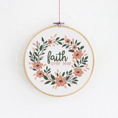 a cross stitch wreath with the words faith over fear