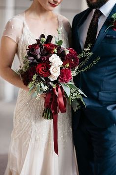 a bride and groom pose for a wedding photo