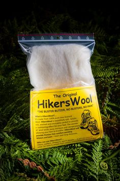 the original hiker's wool is packaged in a plastic bag on top of some green plants