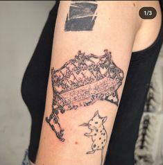 a woman with a tattoo on her arm has a drawing of a bench in the background