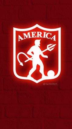 a red brick wall with an american football logo on it and a neon sign that reads,