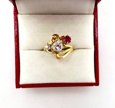 Contemporary Estate Custom 14K 585 Yellow Gold Diamond & Ruby Ring, Size 5 1/2. This is a custom made ring from three antique stones. The center largest stone is a 1/2 Carat Diamond. Flanked by a .20 Carat European Cut Diamond and a 1/4 carat antique ruby. Stunning design and color. The largest diamond is nearly flawless. The smaller diamond has a tiny chip. Would make a very creative engagement ring. The ring is hallmarked 14K for gold content. Weighs 4.3 grams. Excellent clean condition. C Vintage Yellow Gold Three-stone Jewelry, Vintage Yellow Gold Three Stone Jewelry, Vintage 14k Gold Three-stone Rings, Vintage 14k Gold Three Stone Rings, Vintage Yellow Gold Three Stone Rings, Heirloom Three Stone Ruby And Diamond Ring, Heirloom Three Stone Ruby Ring With Diamonds, Heirloom Yellow Gold Three Stone Ring, Heirloom Three-stone Ruby Ring With Diamonds