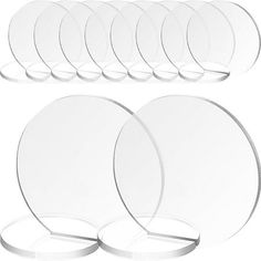 a set of six clear plates with white rims on each plate, and four round plates