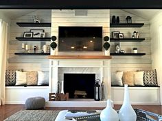 a living room filled with furniture and a fire place in front of a flat screen tv