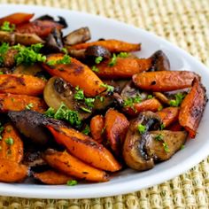 a white plate topped with carrots and mushrooms