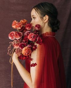 a woman in a red dress holding flowers