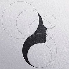 an abstract logo with the shape of a woman's head and circles around it