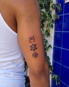 a man with a tattoo on his arm that has animals and spirals in it