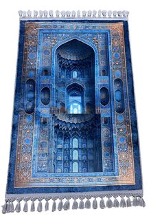 an intricately designed blue rug with tassels hanging from it's sides